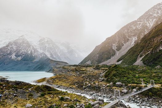 Hooker Valley Track hiking trail, New Zealand. View of Aoraki Mount Cook National Park with snow capped mountains.