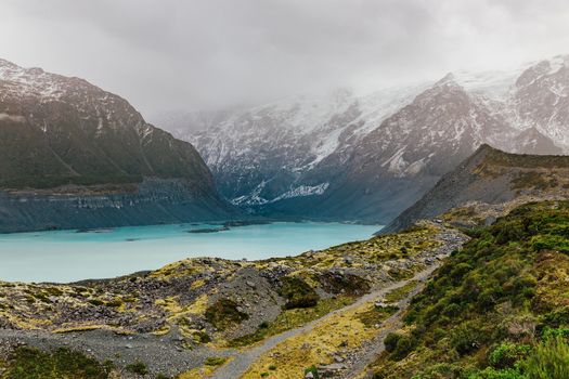 Hooker Valley Track hiking trail, New Zealand. View of Aoraki Mount Cook National Park with snow capped mountains.