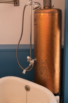 Large old rusty bath water heater made of copper for heating and hot water preparation