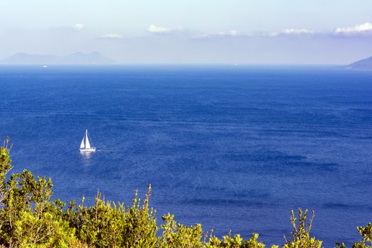 White sailboat in the sea. Summer season nature background.