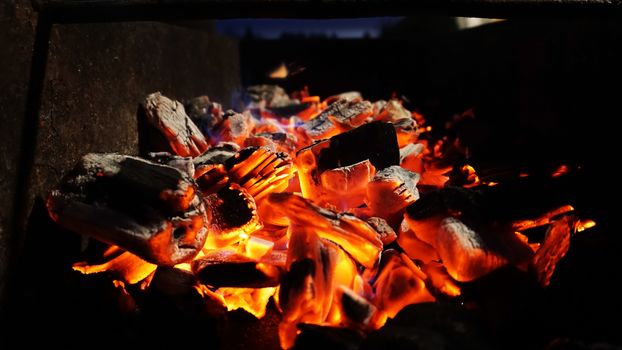 Embers fire fireplace grill fire flame, black background - bright photo