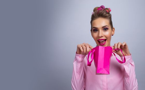 Shopping, sale, christmas and holiday concept - smiling woman with small shopping gift bag