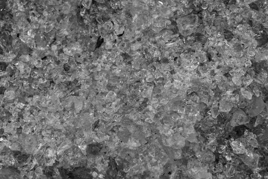 pile of crushed glass crystals in macro closeup, black and white texture pattern background