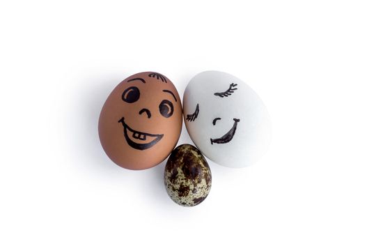 Funny eggs imitating a happy mixed family with versicolored baby on white background