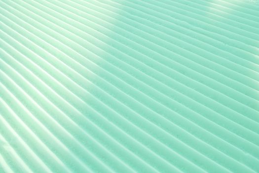 Background of diagonal geometrical parallel stripes of snow colored with light shade