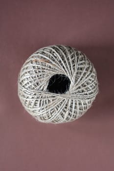 Top view of ball of rope on brown background
