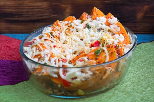Vegetarian salad of orange pumkin, mixed vegetables, herbs and cheese