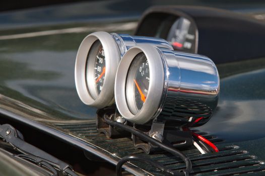 External gauges outside on the hood of a modified car.