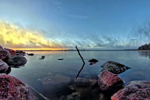 Frozen surface of the sea in the early morning at sunrise after first cold night of the year