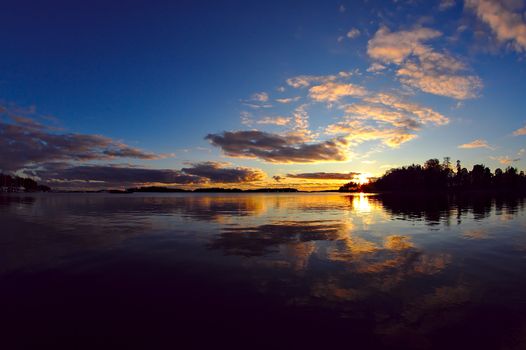 Beautiful summer night sunset reflecting from water surface.