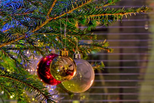Sparkling ornaments on a christmas tree on Christmas eve.