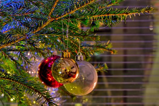 Sparkling ornaments on a christmas tree on Christmas eve.