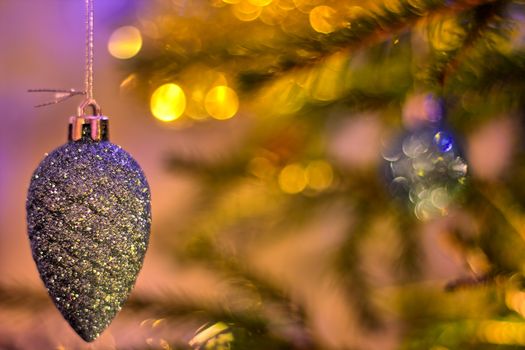 Cone shaped christmas tree decoration on a blurred background.