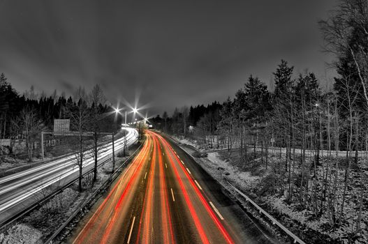 Late night rush hour. People driving home from work in the city. Light trails, long exposure.