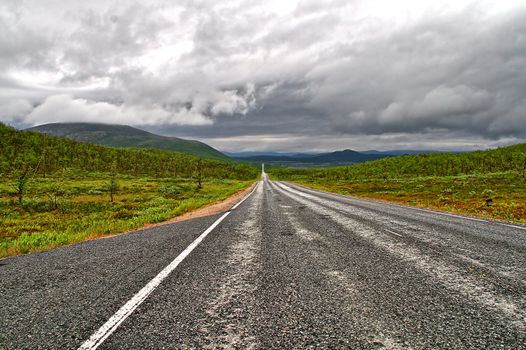 Endless empty road in Finnish Lapland. Also called as Northern Lights route.