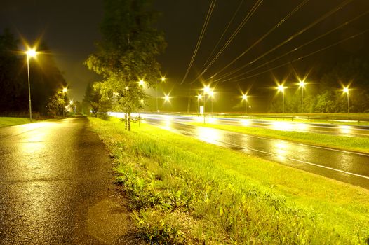 Late night after rain on a motorway. Street light reflecting from wet tarmac.