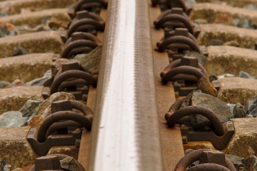 Closeup of a single rail of a railway.