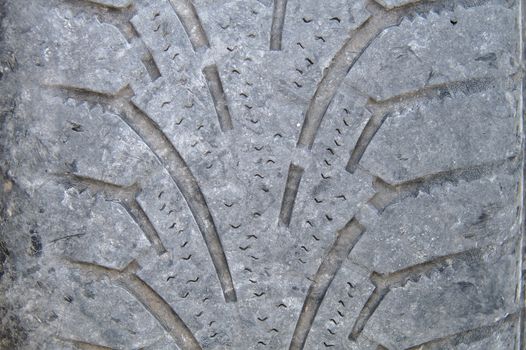 Closeup of a worn out tire of a car. Tires have to be changed before winter in northern countries.