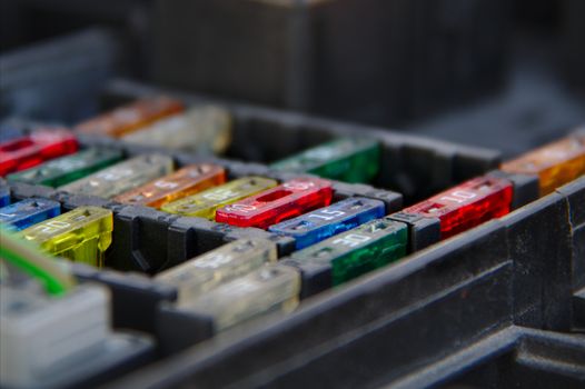 Multiple rows of fuses in the fusebox of a car.