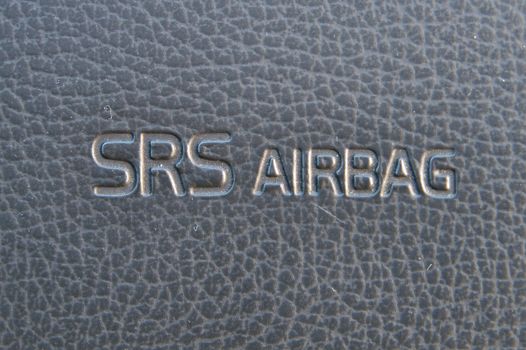 SRS Airbag warning text on passanger side dasboard of a car.