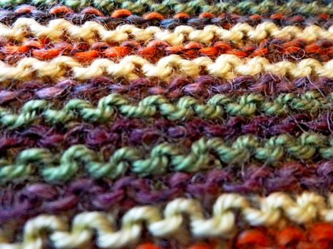 Knitted multicolored fabric texture. Background image Close-up. Hobbies, leisure, crafts