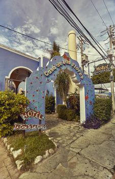 Blue entrance arch belonging to a typical building of the city of Playa del Carmen in Mexico.