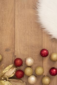 Christmas background. Gold Christmas balls on a wooden background. Winter holidays concept. Top view with copy space, vertical image.