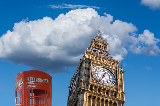British Red Telephone Booth and Big Ben in London.England landmark in front of a blue sky