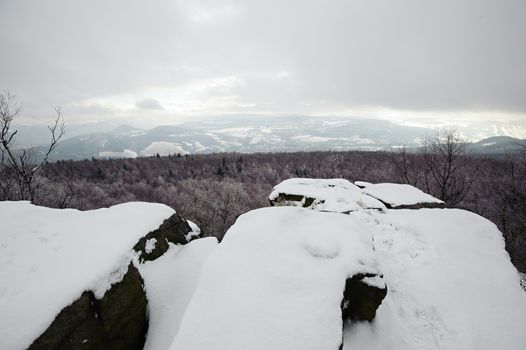 Winter landscape covered with snow and snow clouds