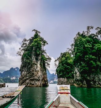 Blue sky green sea boat and mountain