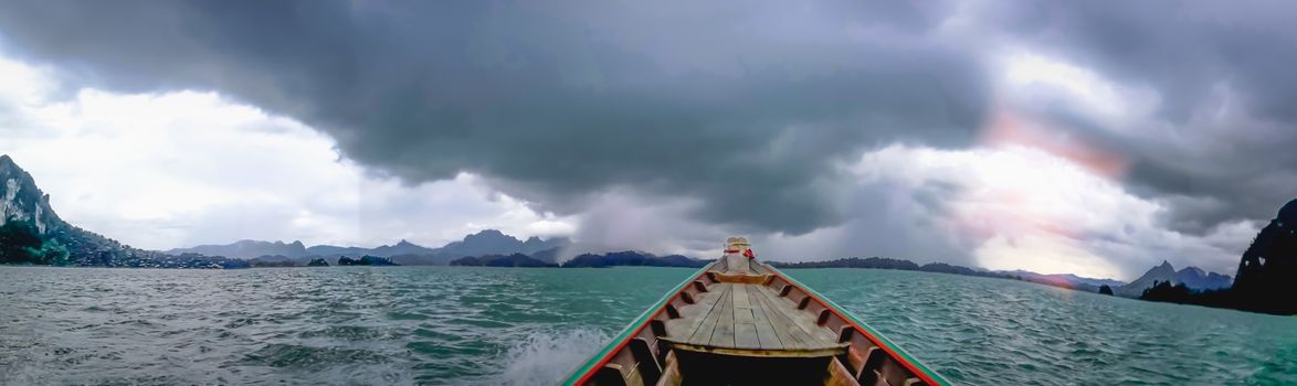 Blue sky green sea boat and mountain