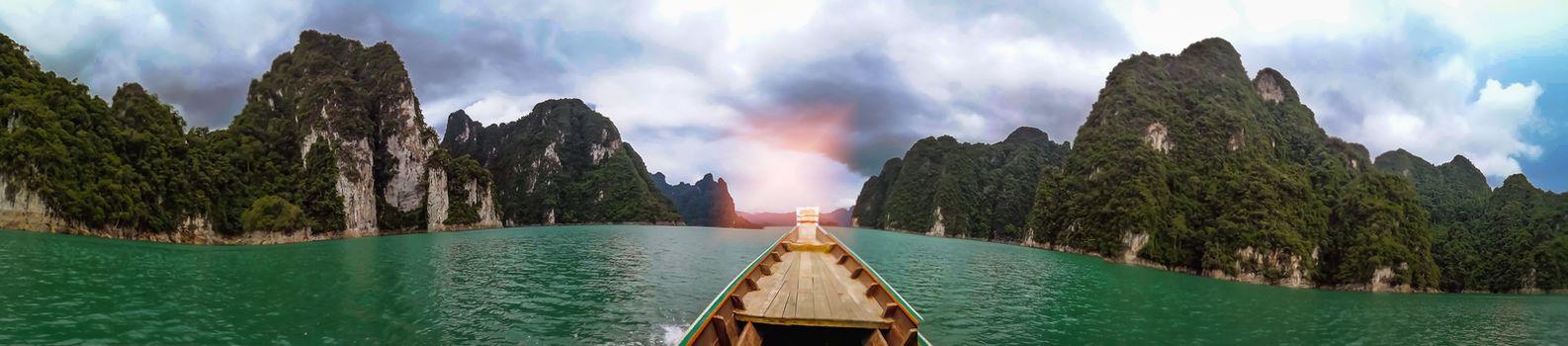 Blue sky green sea boat and mountain