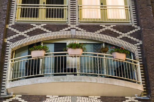 modern city balcony decorated with flower baskets