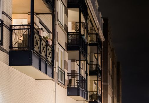 Modern apartment balcony's with metal frameworks in closeup at night, dutch architecture background