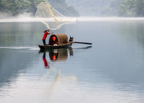 A fisherman in the famous Misty Small Dongjiang (east river) in Chenzhou, Hunan province of China.