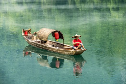 A fisherman in the famous Misty Small Dongjiang (east river) in Chenzhou, Hunan province of China.