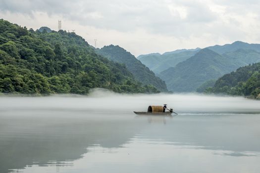 A fisherman in the famous Misty Small Dongjiang (east river) in Chenzhou, Hunan province of China.