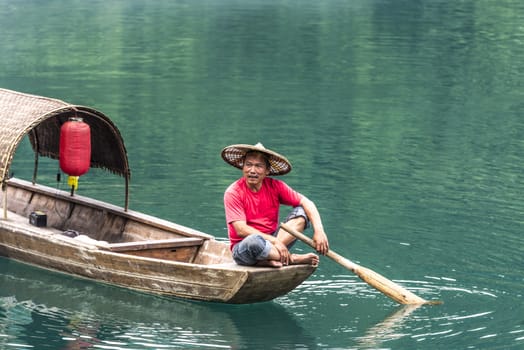 A fisherman in the famous Misty Small Dongjiang (east river) in Chenzhou, Hunan province of China.