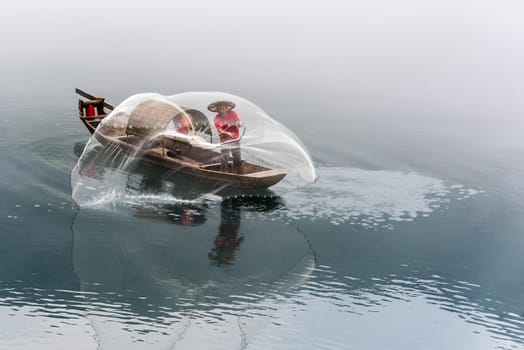 A fisherman in the famous Misty Small Dongjiang (east river) in Chenzhou, Hunan province of China.