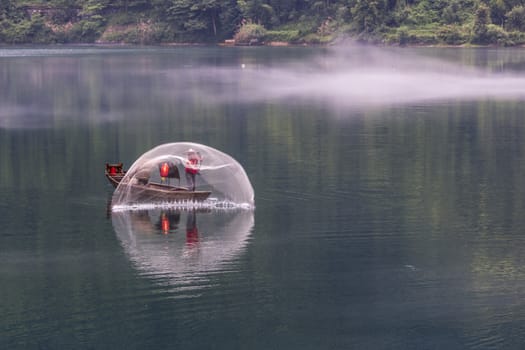 A fisherman in the famous Misty Small Dongjiang (east river) in Chenzhou, Hunan province of China.