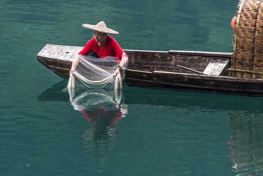 A fisherman in the famous Misty Small Dongjiang (east river) in Chenzhou, Hunan province of China.