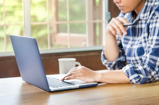 businesswoman using laptop computer  in office. hipster tone