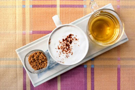 top view a cup of hot coffee and tea served with brown sugar