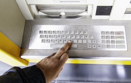 Taking money out of an ATM, detail of cash and finance, consumerism