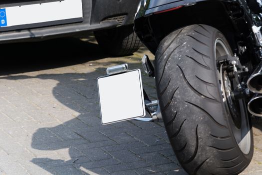 Close up of a large tire of a modern motorcycle parked.
