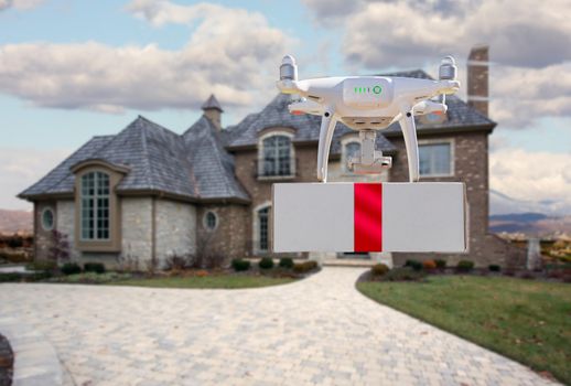 Unmanned Aircraft System (UAV) Quadcopter Drone Delivering Box With Red Ribbon To Home