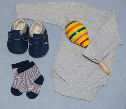 Table top view decoration baby shoes and socks and body suit. Flat lay copy space