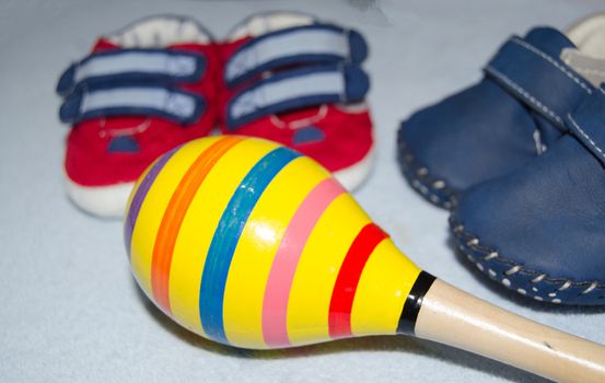 Table top view decoration baby shoes and maracas. Flat lay, copy space