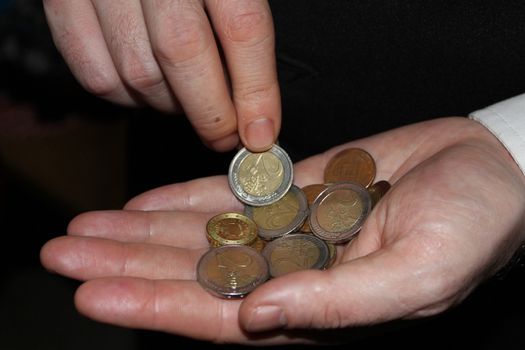 man hand holding a coins, finance concept, counting