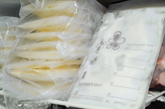 expresed breast milk packed in storage bags and frozen in the freezer, breastfeeding concept